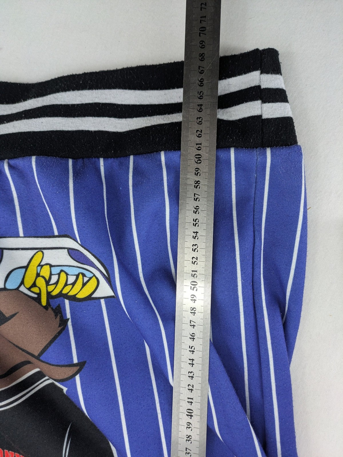Moschino multi turtle neck jumper blue and white striped with Tasmanian Devil graphic.