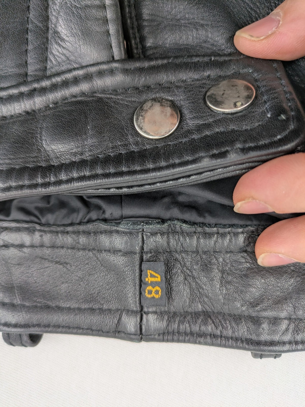 Hein Gericke black leather chaps with studs and wavy decorative seams.
