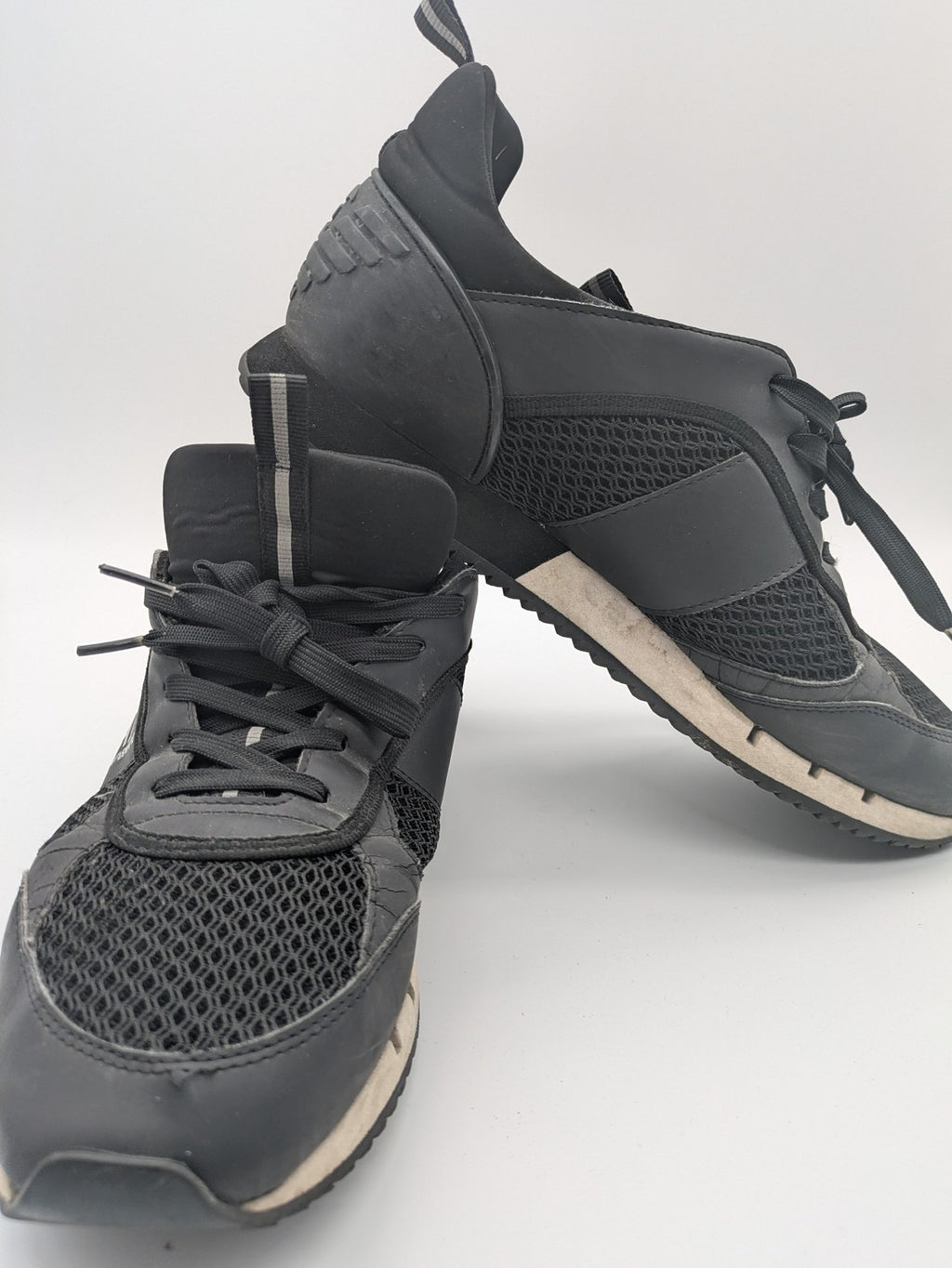 EA7 Emporio Armani beige and black sneakers with prominent EA7 branding and breathable mesh details.