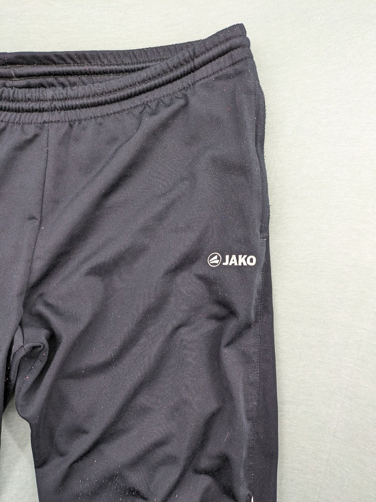 Jako black training pants size L with zippered pockets and elastic waistband.