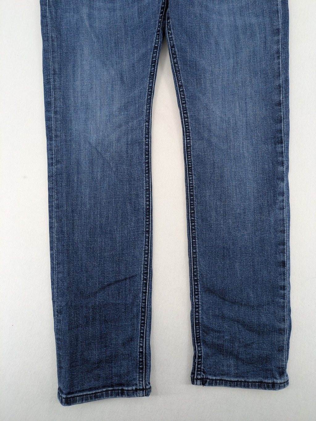 BOSS blue slim fit jeans with logo, five-pocket design, and button fly.