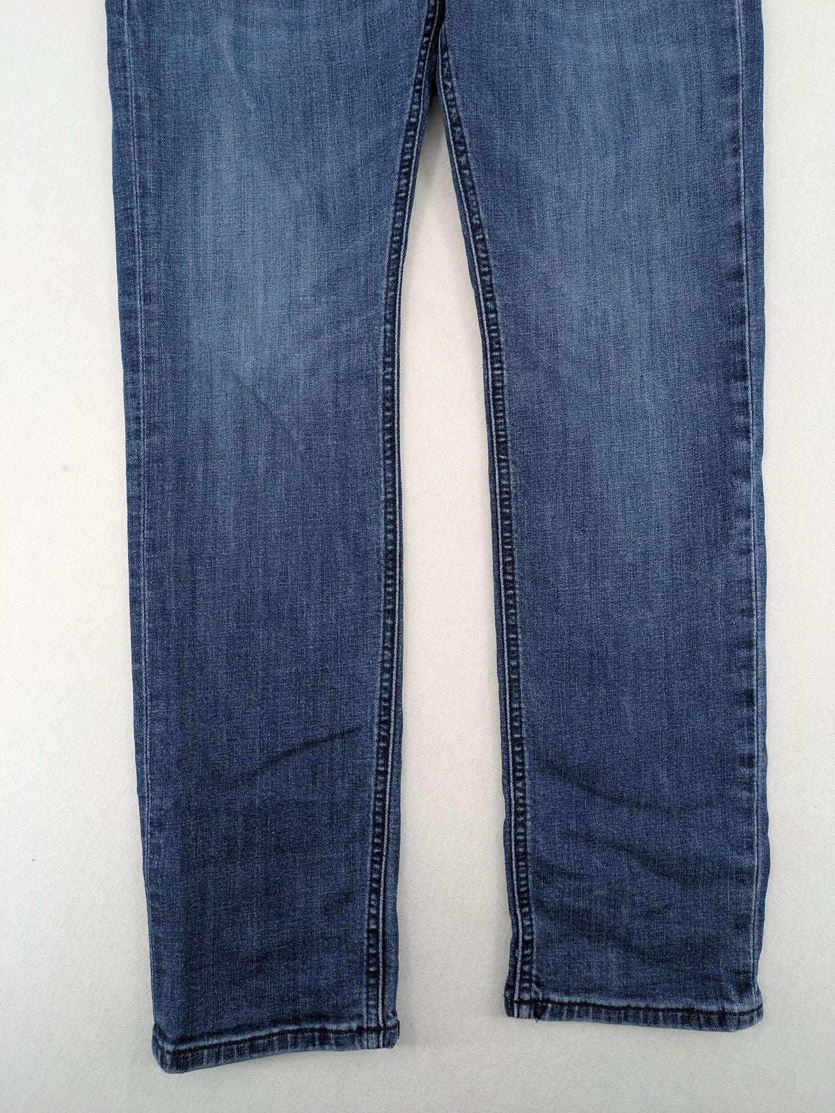 BOSS blue slim fit jeans with logo, five-pocket design, and button fly.