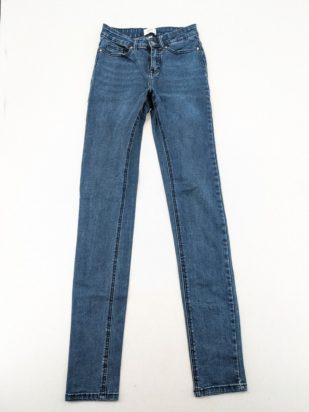 Dust blue skinny jeans with mid-rise waist and classic wash, stretch denim material.