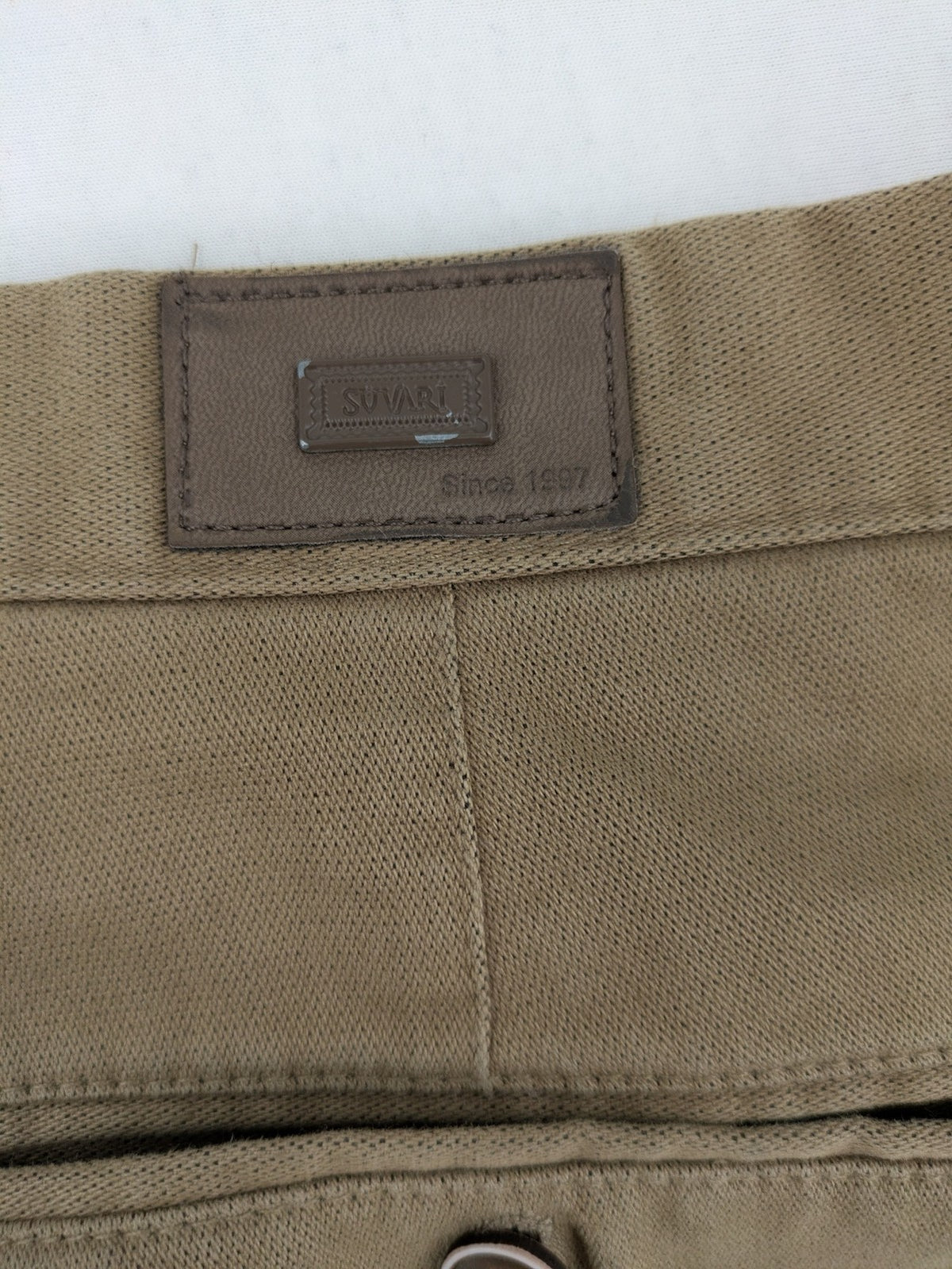 Süvari khaki chino pants flat-front design with patterned waistband detail, cotton blend material.