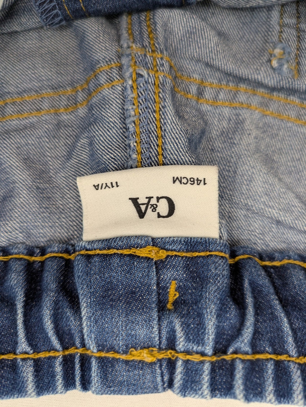 C&A blue denim shorts with elastic waistband and decorative drawstring, classic style.