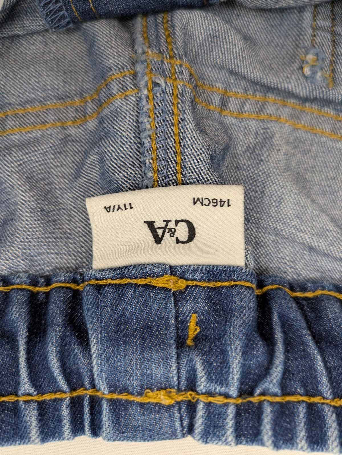 C&A blue denim shorts with elastic waistband and decorative drawstring, classic style.