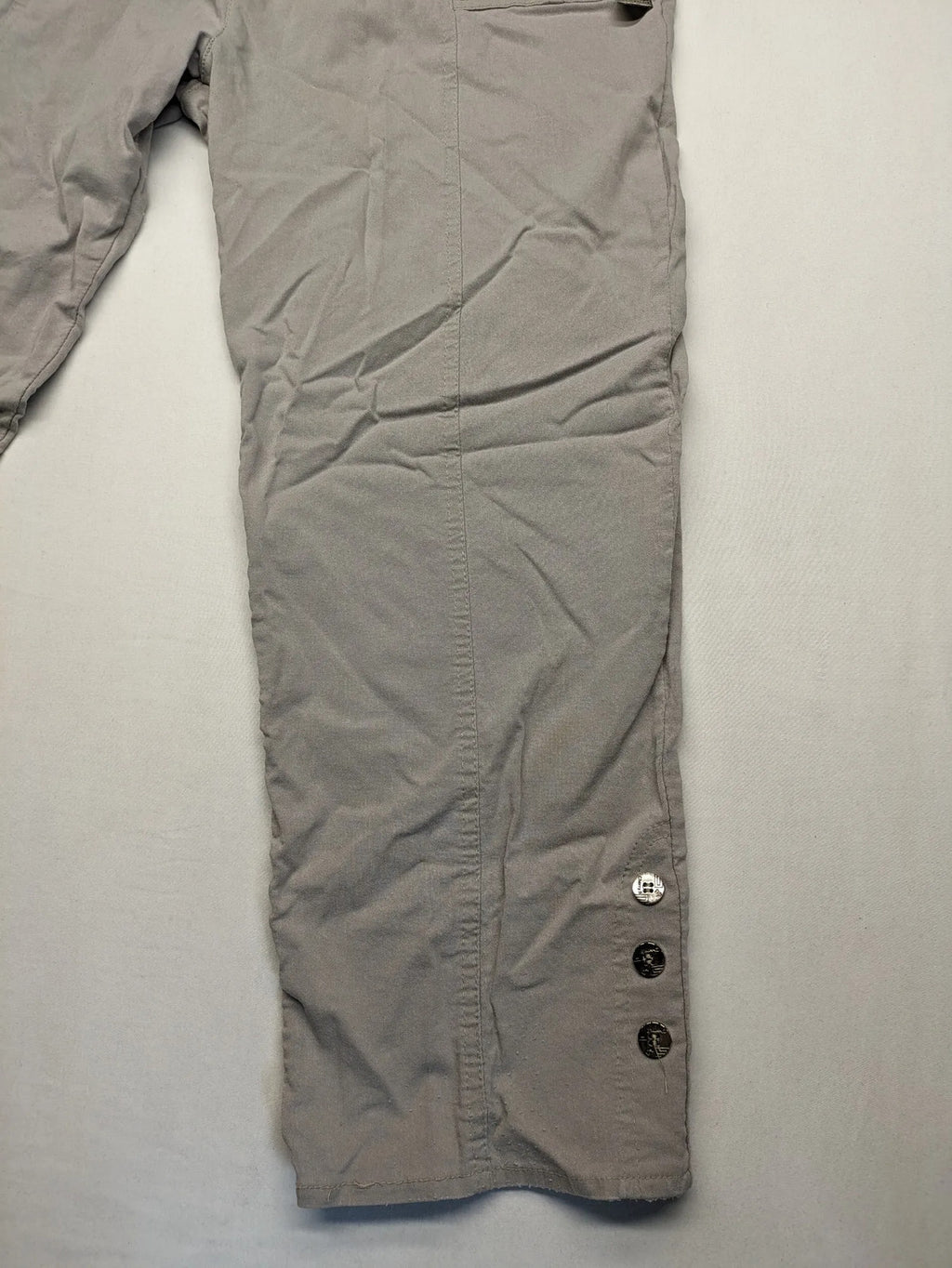 Cherry Berry khaki capri pants with elastic waistband and decorative buttons, featuring logo and zip pockets.