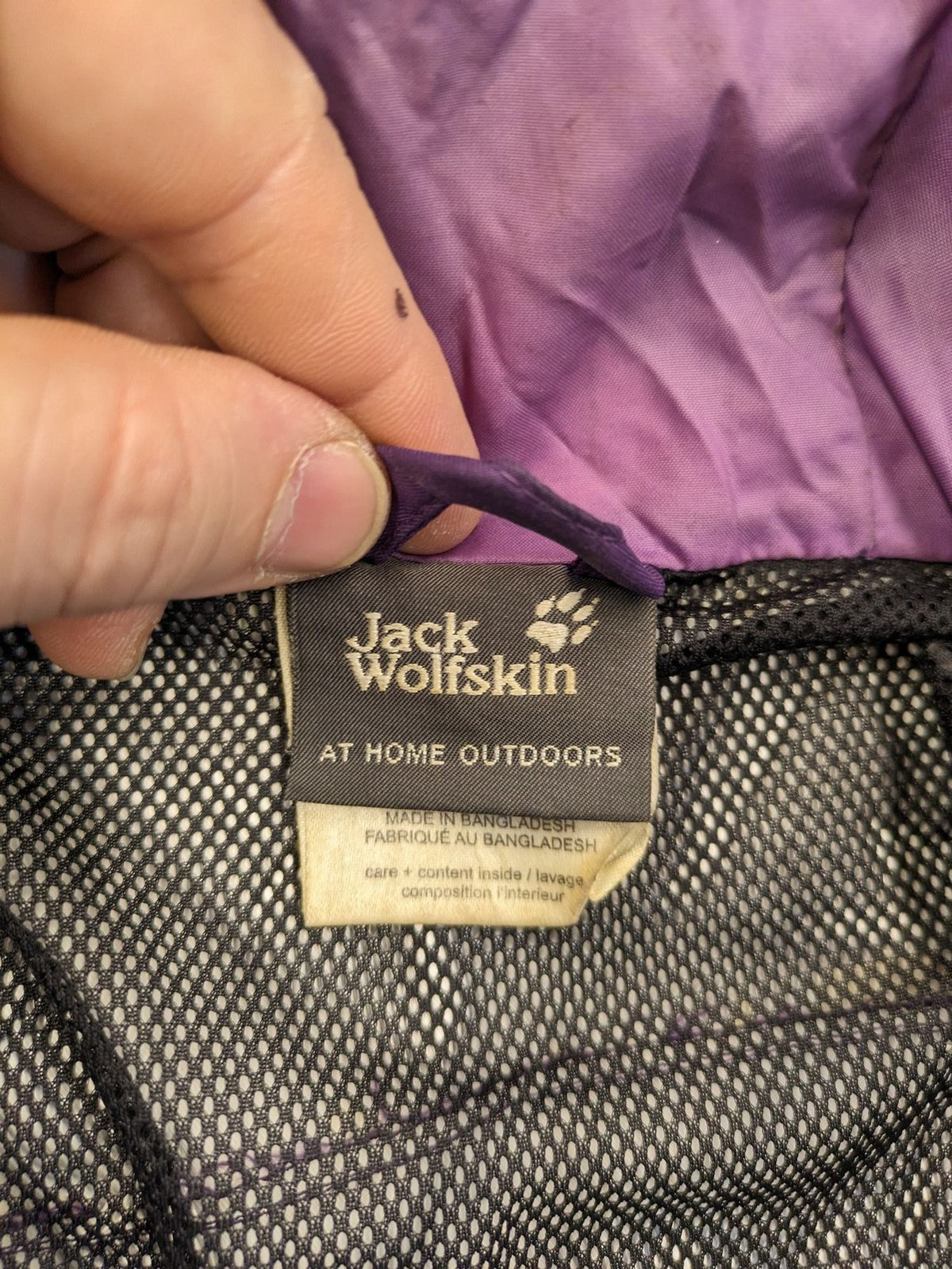 Jack Wolfskin purple outdoor jacket with adjustable hood and full zip, lightweight Stormlock material.