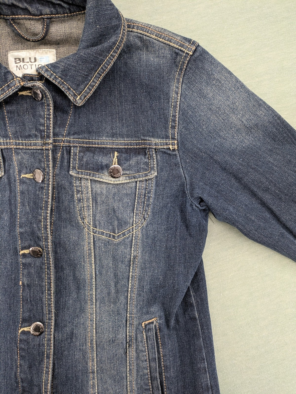 BLU blue denim trucker jacket with button placket and two chest pockets.