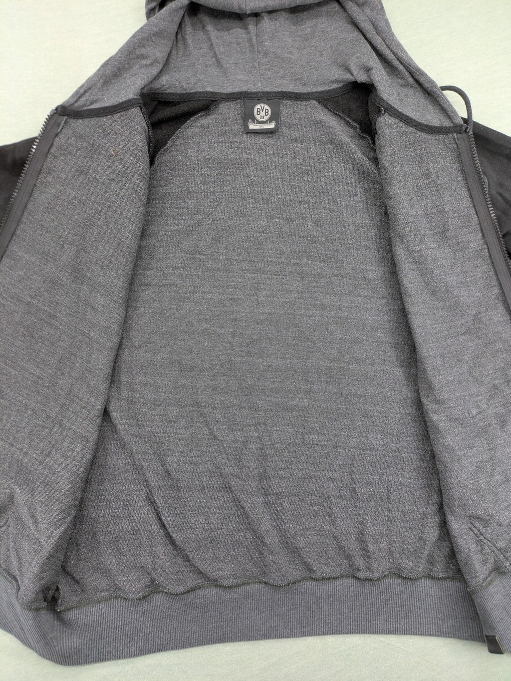 Borussia Dortmund grey and black hoodie with BVB 09 logo and full zip design.