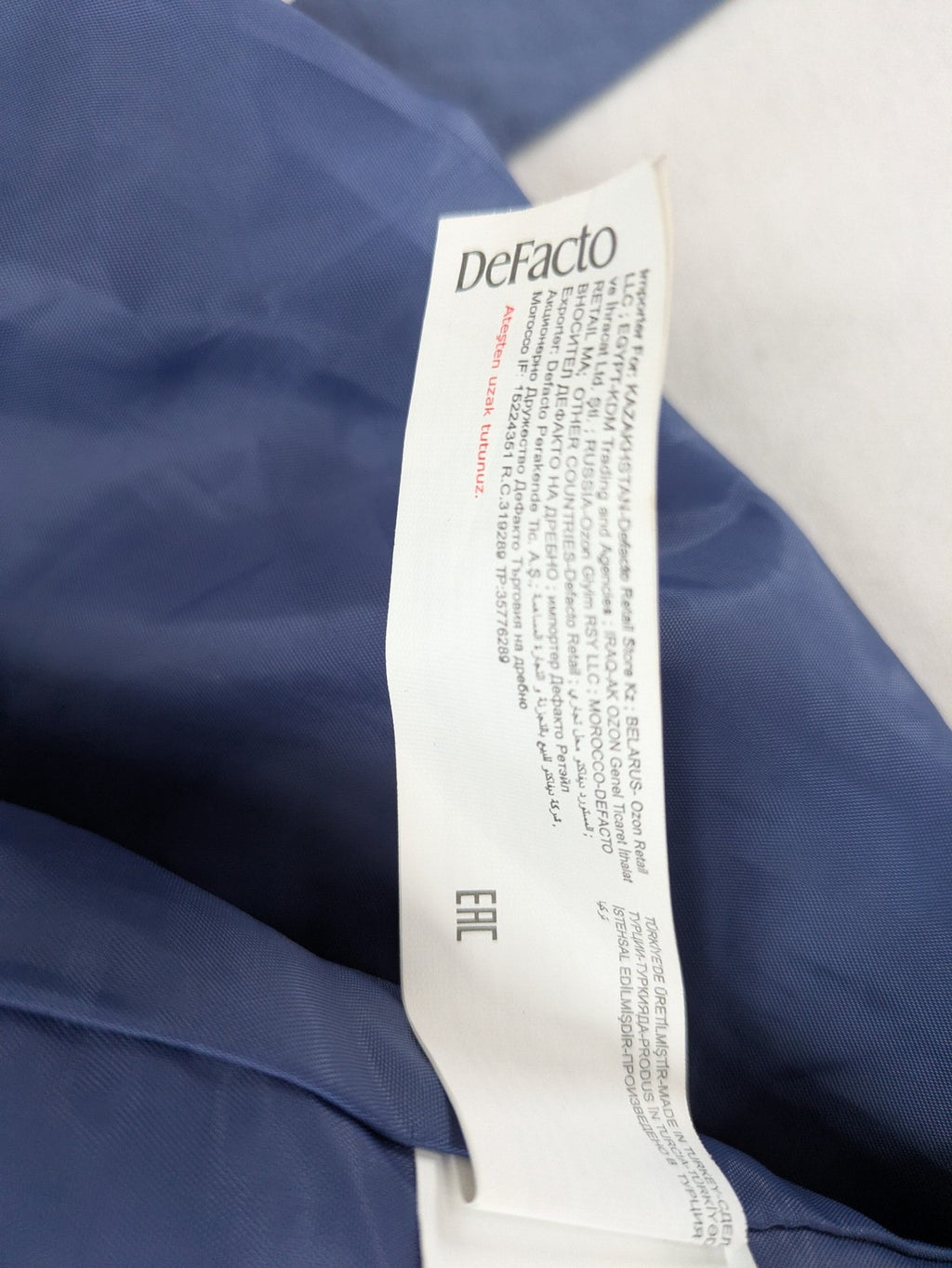 DeFacto blue trench coat with classic lapels and matching self-tie belt.