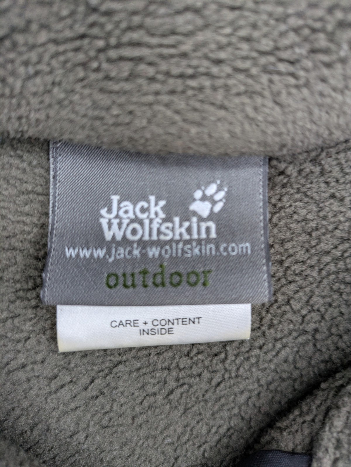 Jack Wolfskin khaki turtle neck jumper with quarter zip and embroidered paw logo.