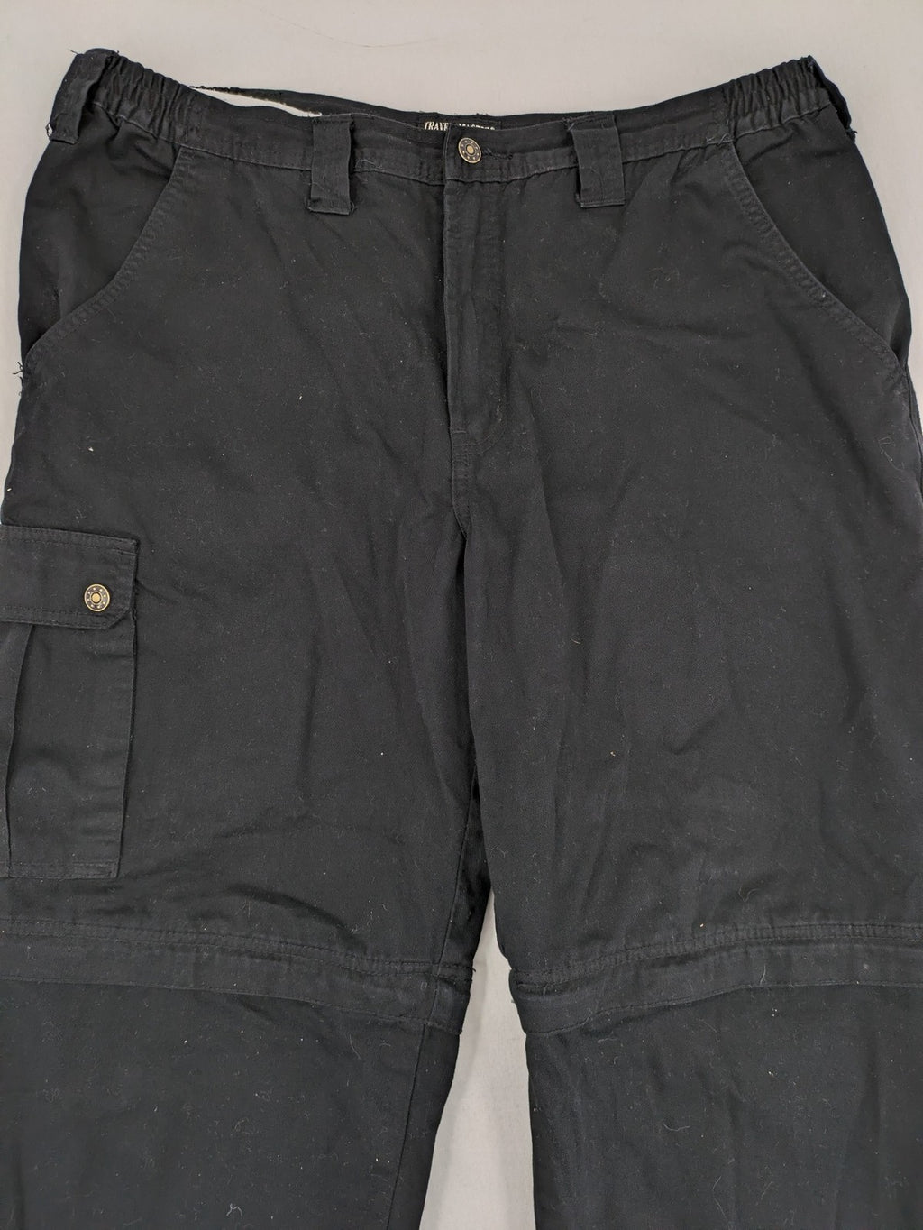 Travel Master black hunting and tactical pants, zip-off design, 100% cotton, multiple pockets.