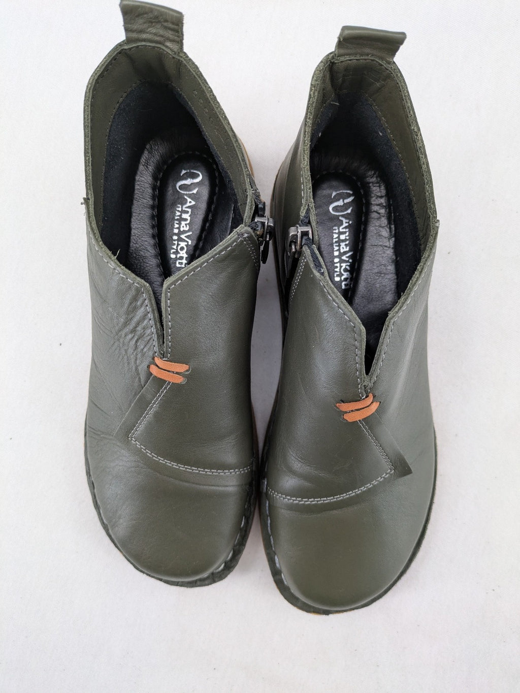 ALS green leather booties with side zipper and decorative stitching.