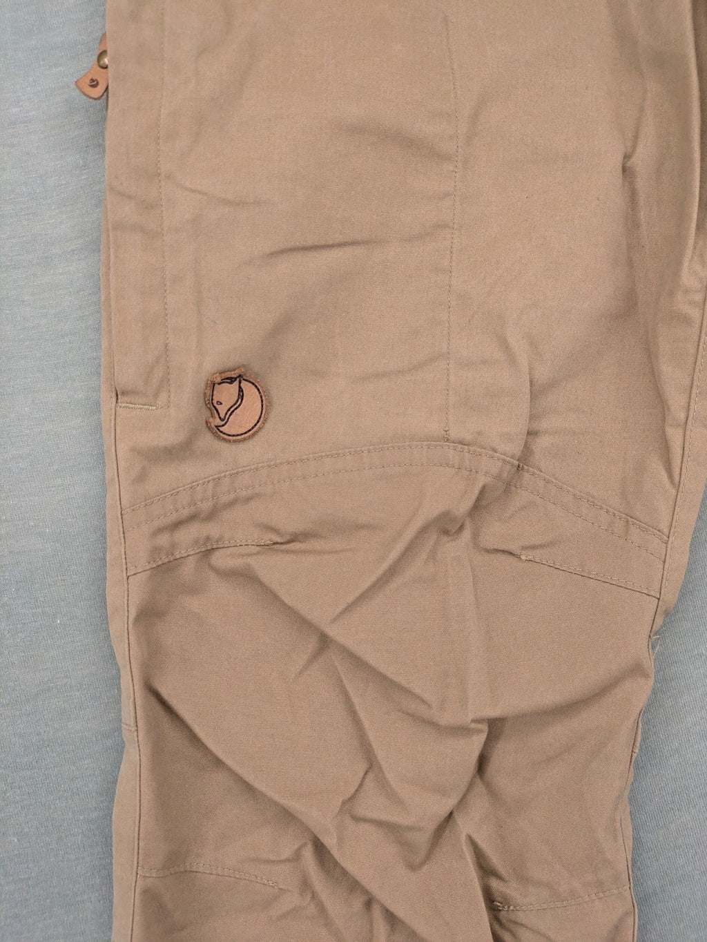 Fjällräven beige pants regular fit durable fabric outdoor style with logo detail.