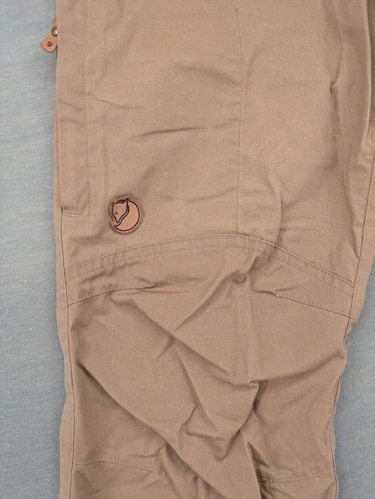 Fjällräven beige pants regular fit durable fabric outdoor style with logo detail.