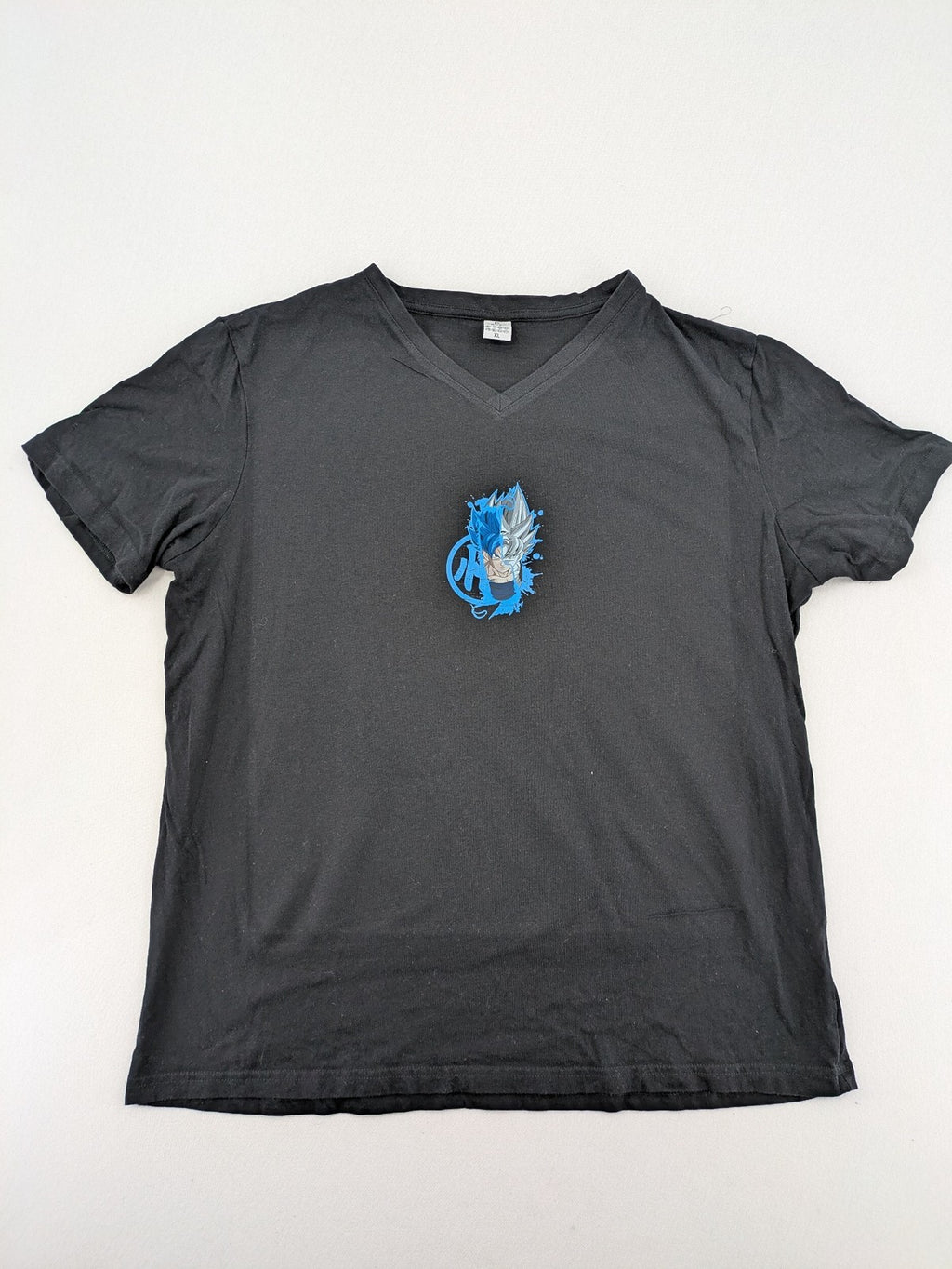 Dragon Ball Super blue t-shirt featuring Goku graphic in Super Saiyan and Ultra Instinct forms.