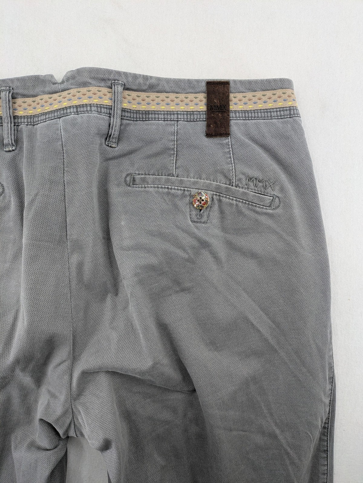 MMX grey chino pants with patterned interior lining and contrasting waistband, made from organic cotton.