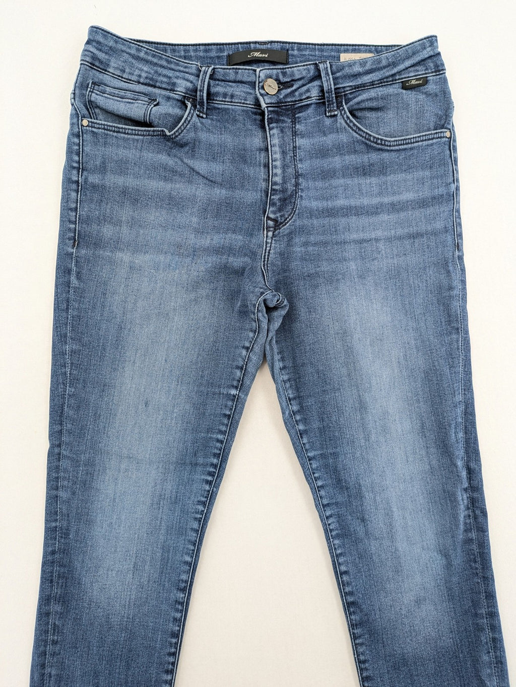 Mavi blue high rise super skinny jeans with medium wash and stretch denim material.