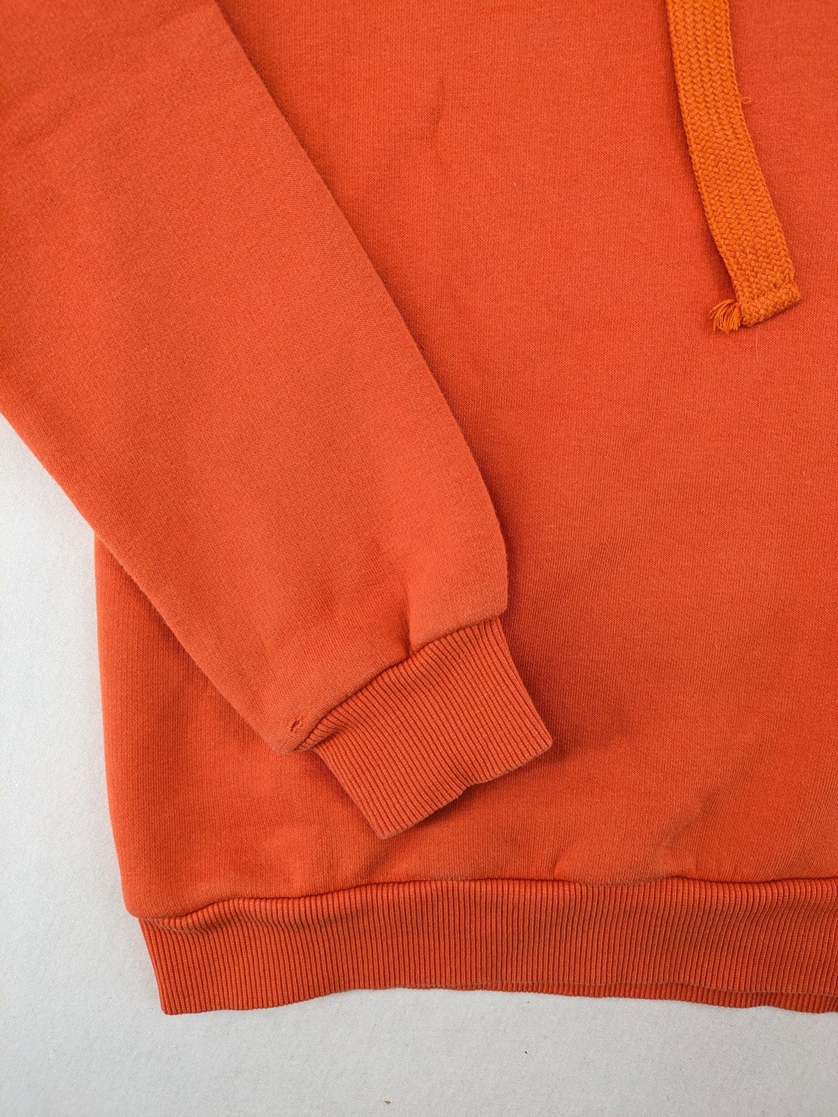 Ginatricot orange hoodie with embroidered winking eye detail, soft material, classic fit.