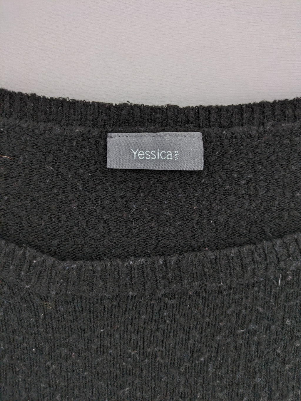 Yessica black turtle neck jumper with sequin "Let's Celebrate" graphic and star details.