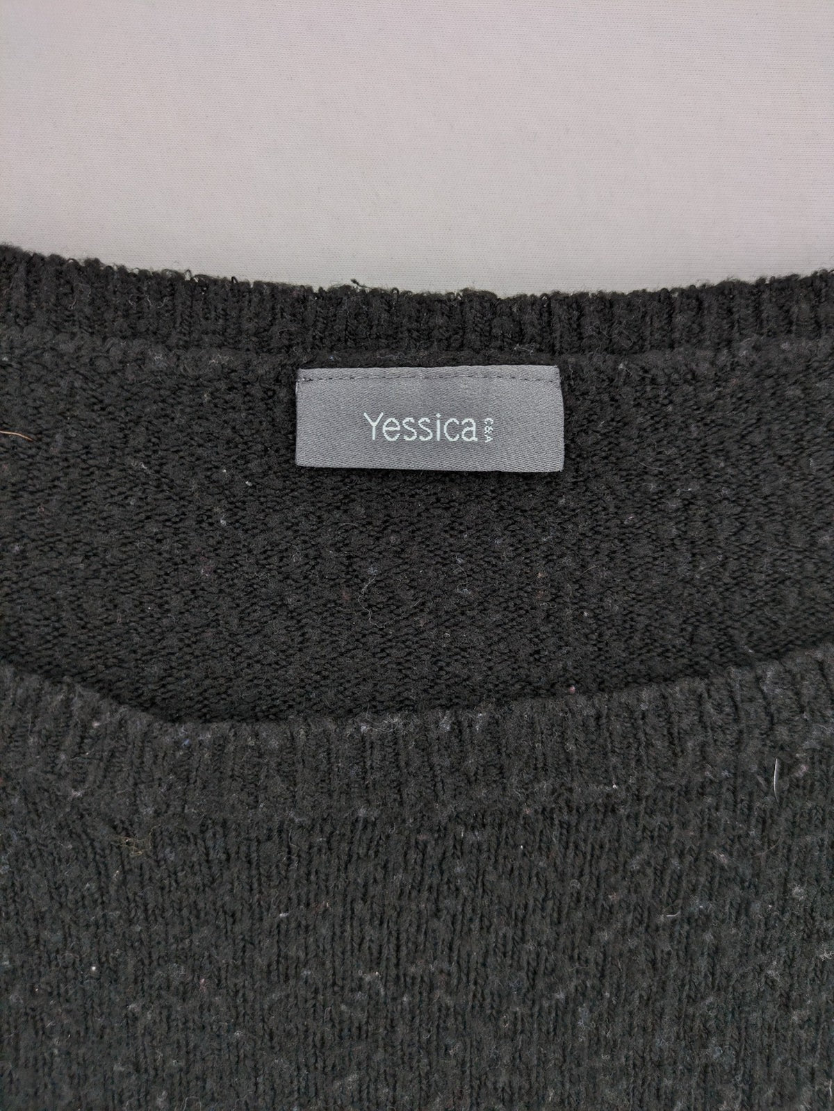Yessica black turtle neck jumper with sequin "Let's Celebrate" graphic and star details.