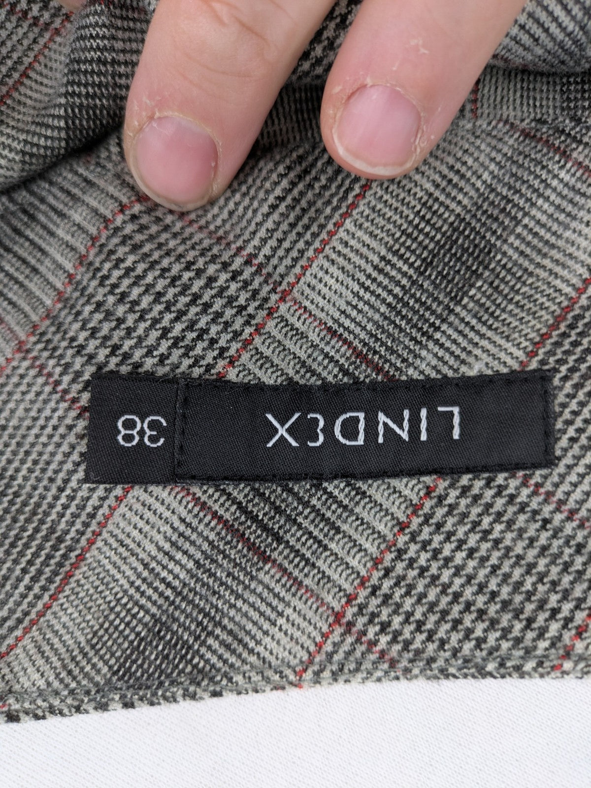 Lindex grey checkered bermuda shorts with red accents, high waist, decorative button detail.