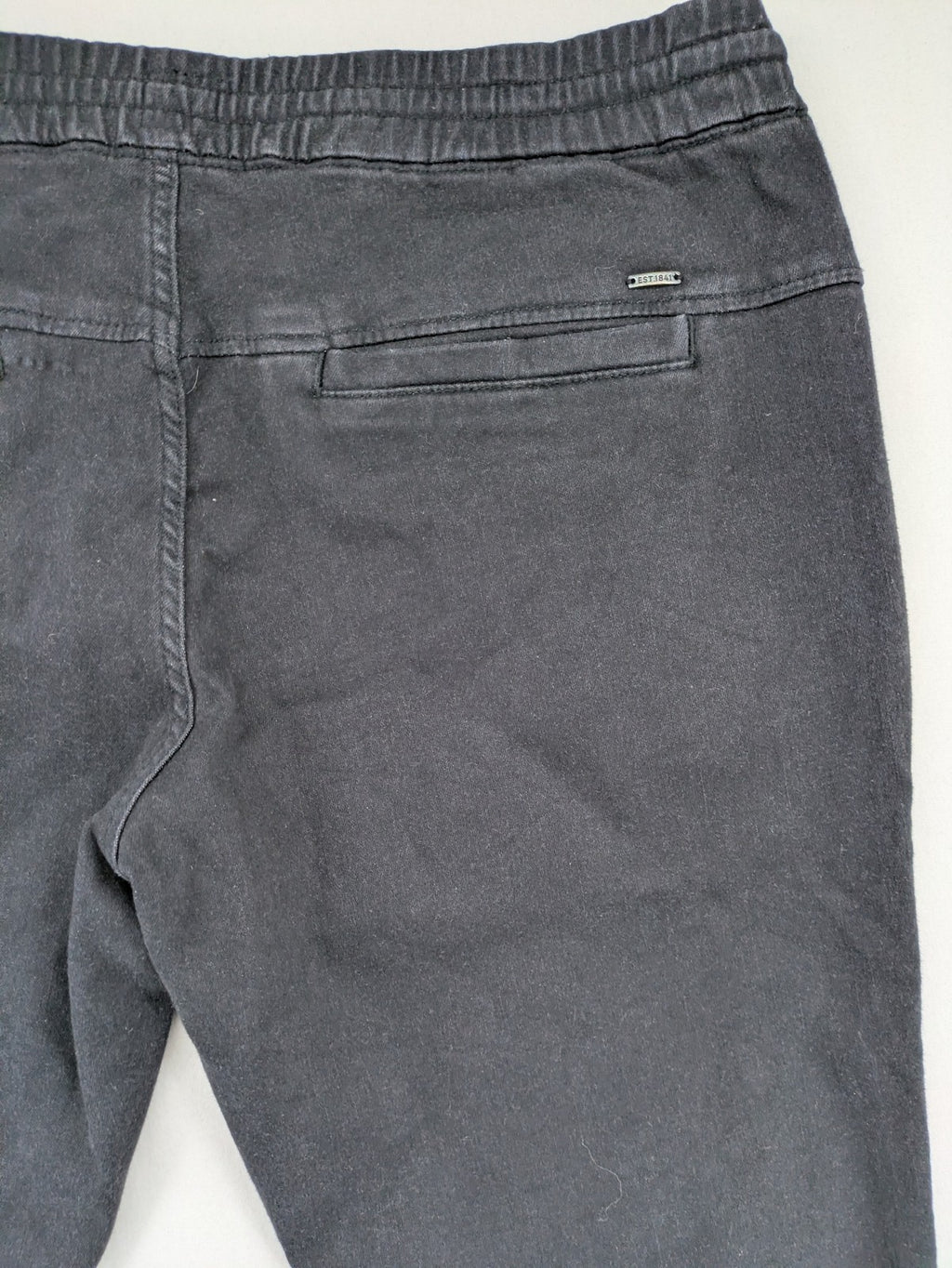C&A grey jogger pants with elastic cuffs, drawstring waist, and multiple pockets.