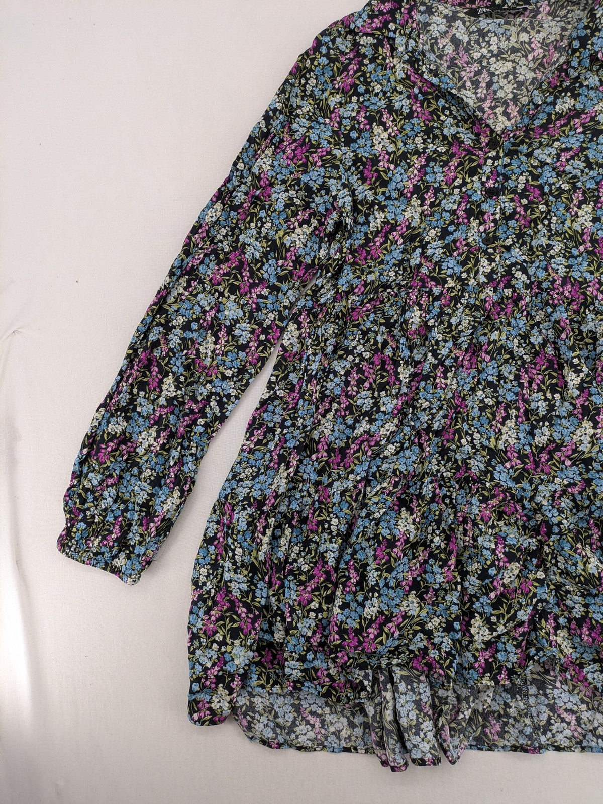 Zara multi-coloured floral mini dress with classic collar and button placket on black background.