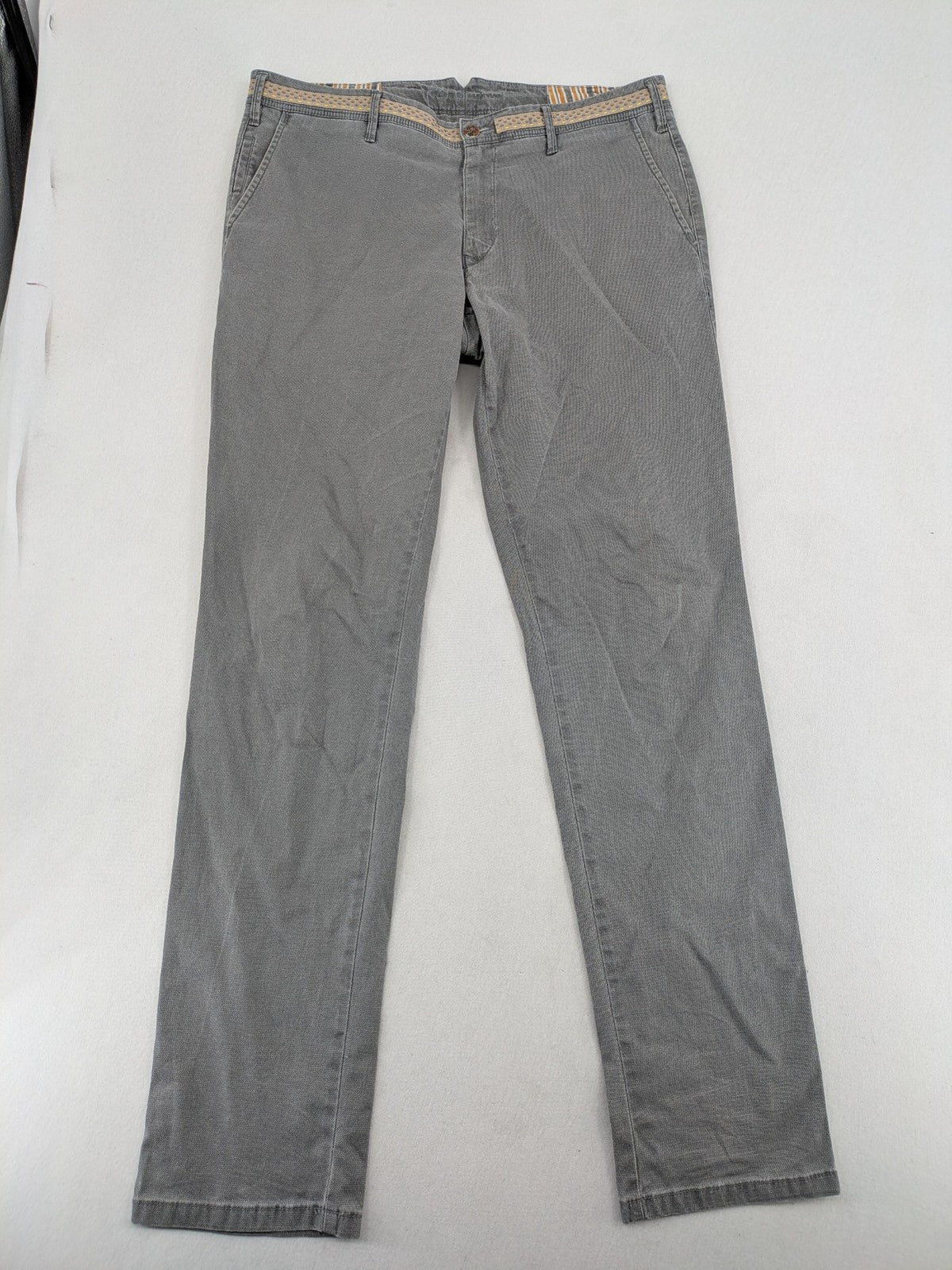 MMX grey chino pants with patterned interior lining and contrasting waistband, made from organic cotton.