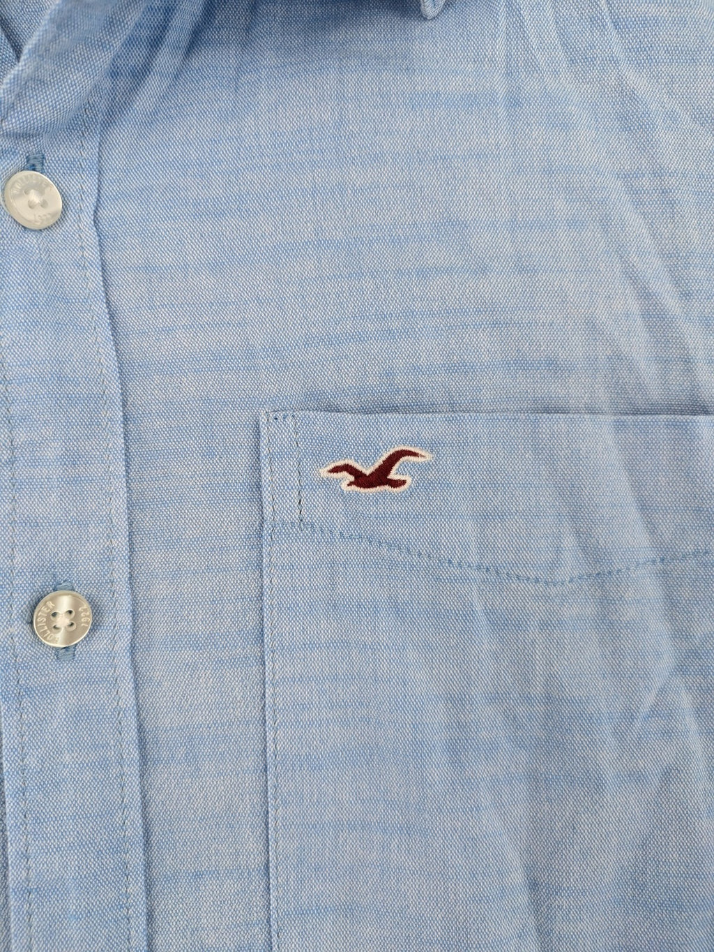 Hollister blue button-down shirt slim fit with embroidered logo and chest pocket.