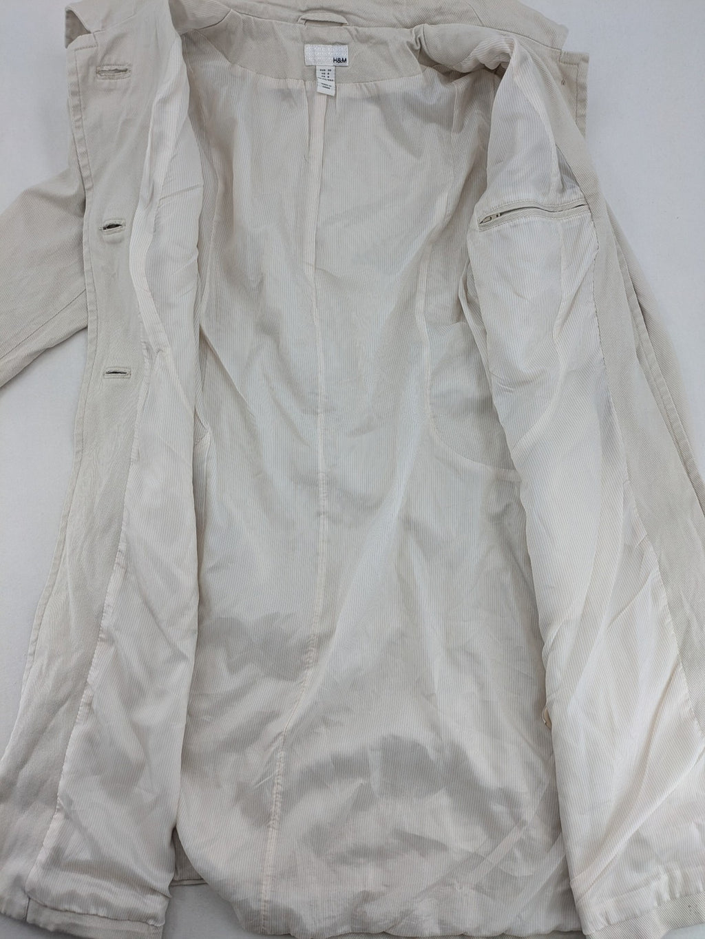 H&M beige trench coat size 38, classic design with button closure and striped lining.
