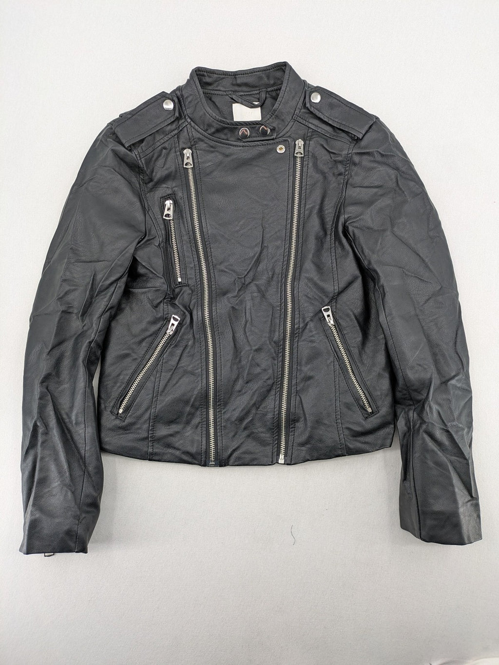 H&M black biker jacket with silver zippers, shoulder flaps, and snap-button details.