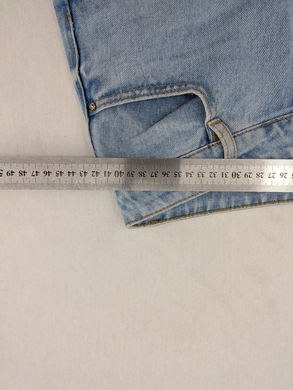Laulia blue wide leg jeans with distressed knee rips and high waist design.