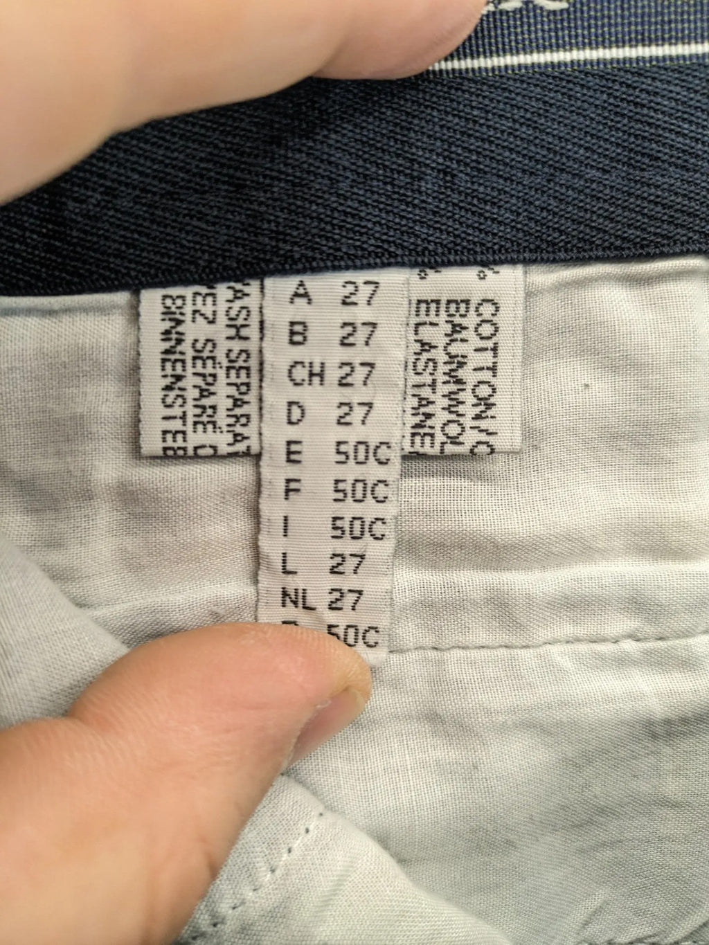 REI blue straight jeans with front pleats, zip fly, and buttoned back pockets.