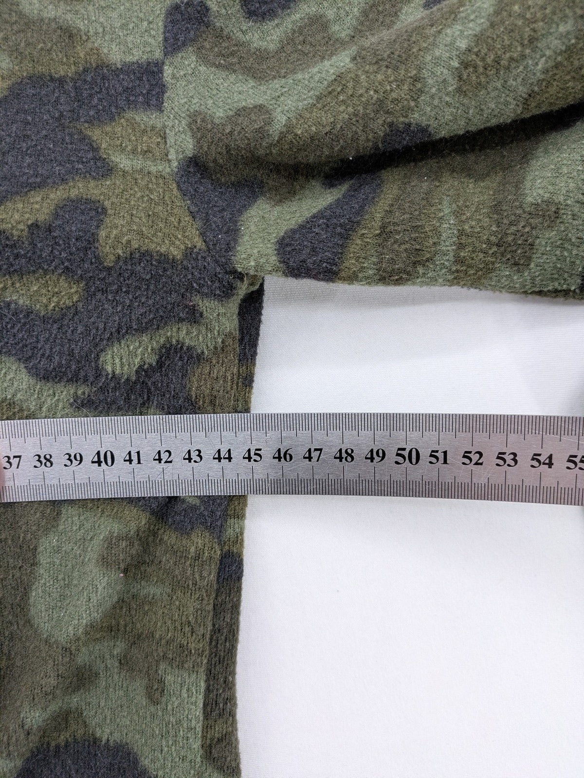 YFK turtle neck jumper multi camouflage print with sequined "COOL MOOD Today" graphic.