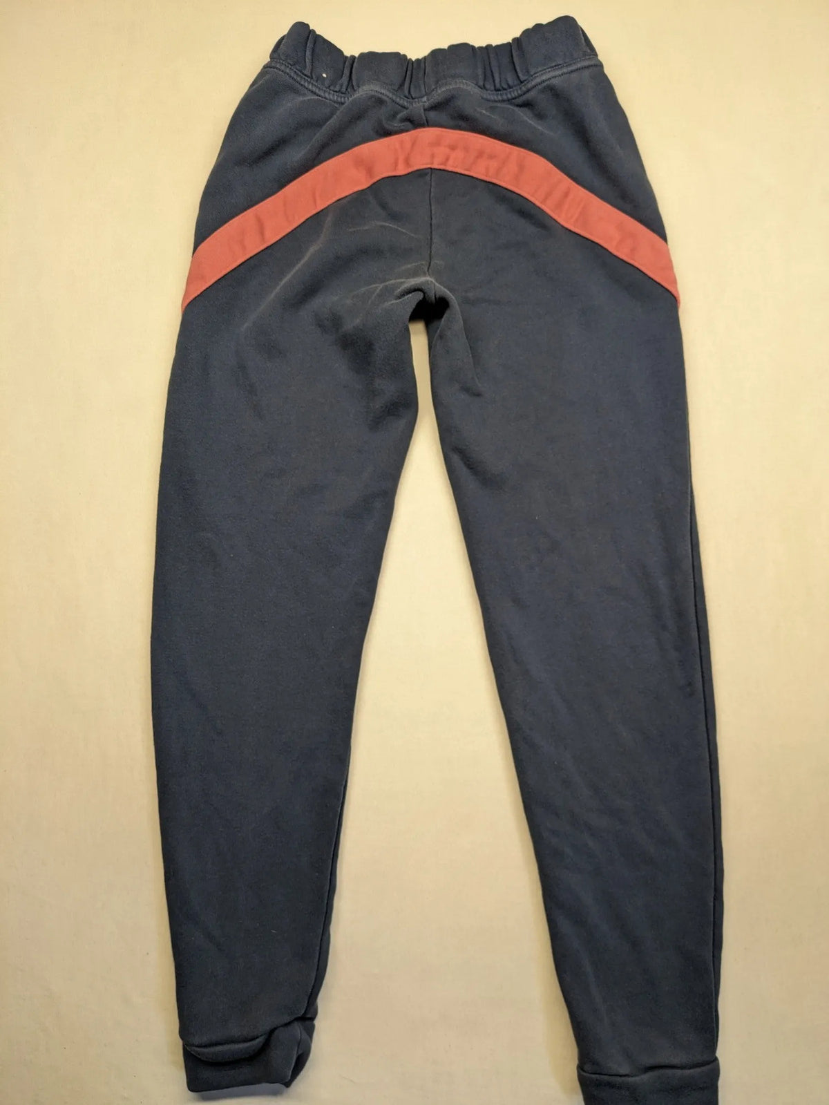 Adidas grey joggers with pink stripes and iconic logo on thigh.