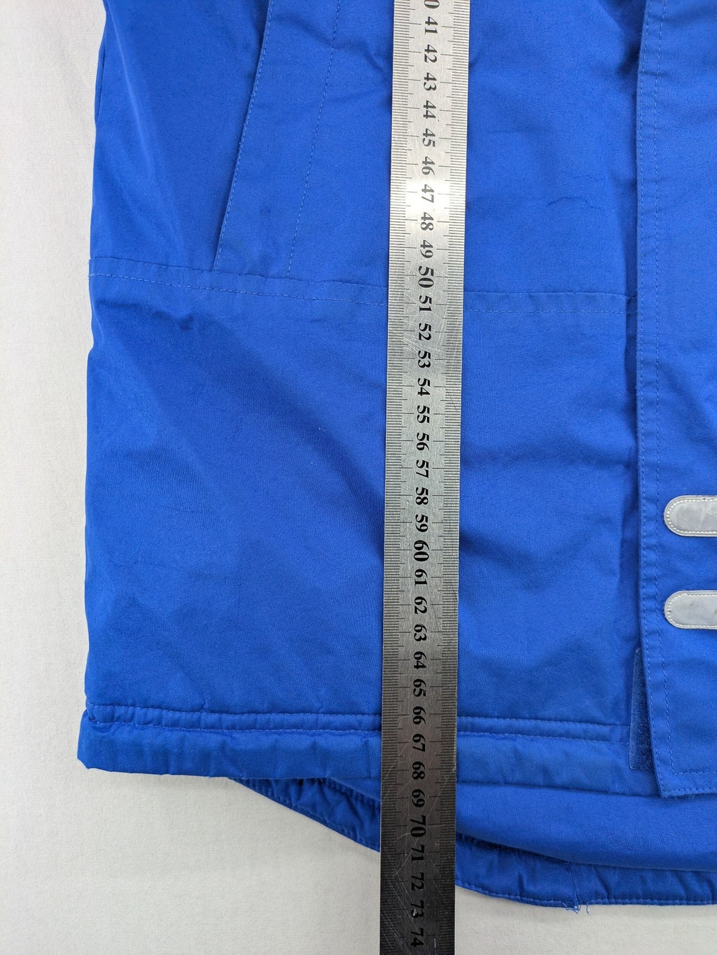 Umbro blue fleece-lined jacket with hood, reflective details, and white piping.