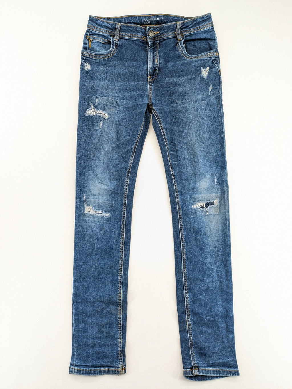Denim & Co. blue skinny jeans with distressed ripped details and adjustable waistband.