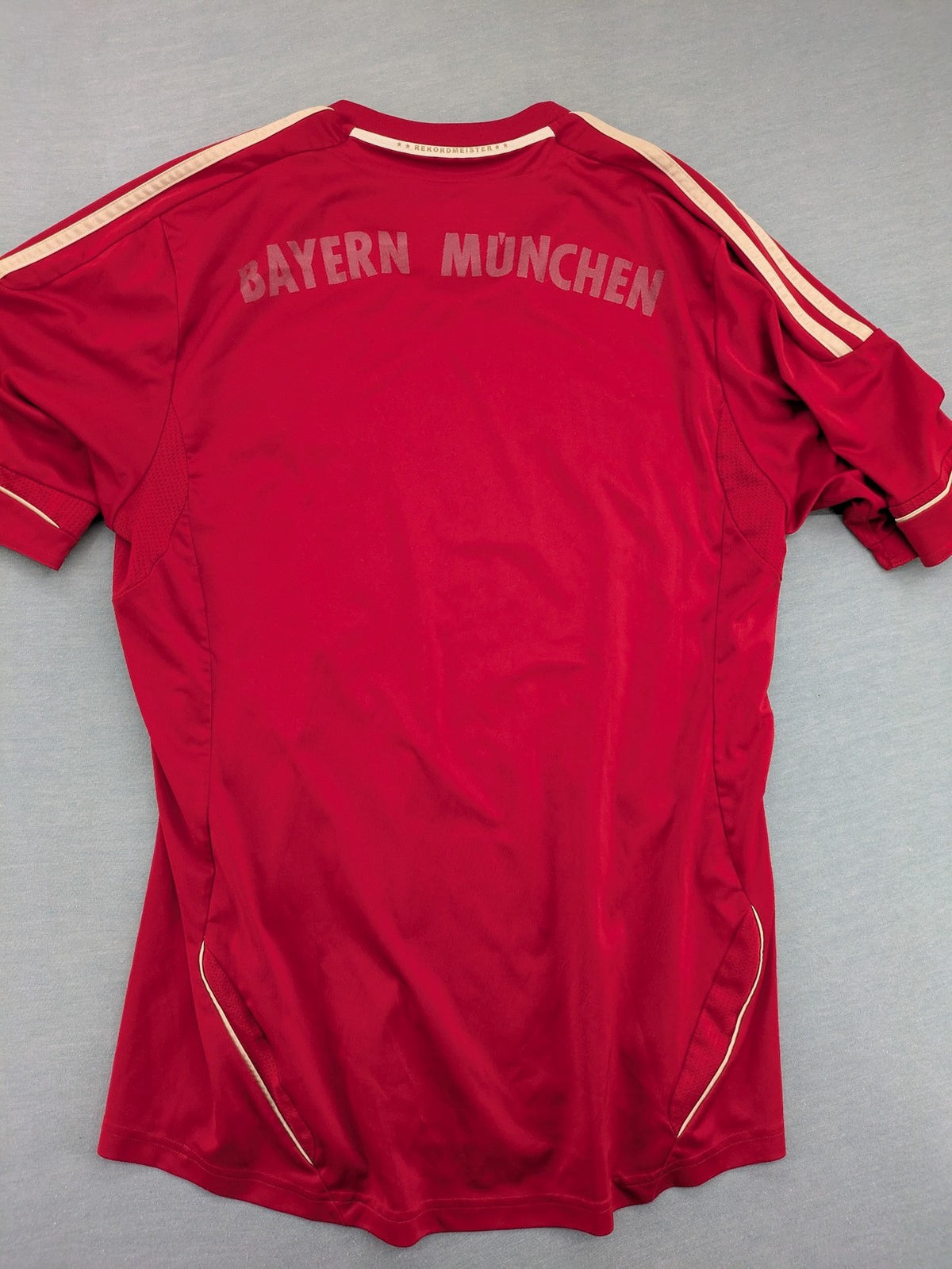 Adidas red soccer uniform with embroidered FC Bayern München crest and T-Mobile logo.