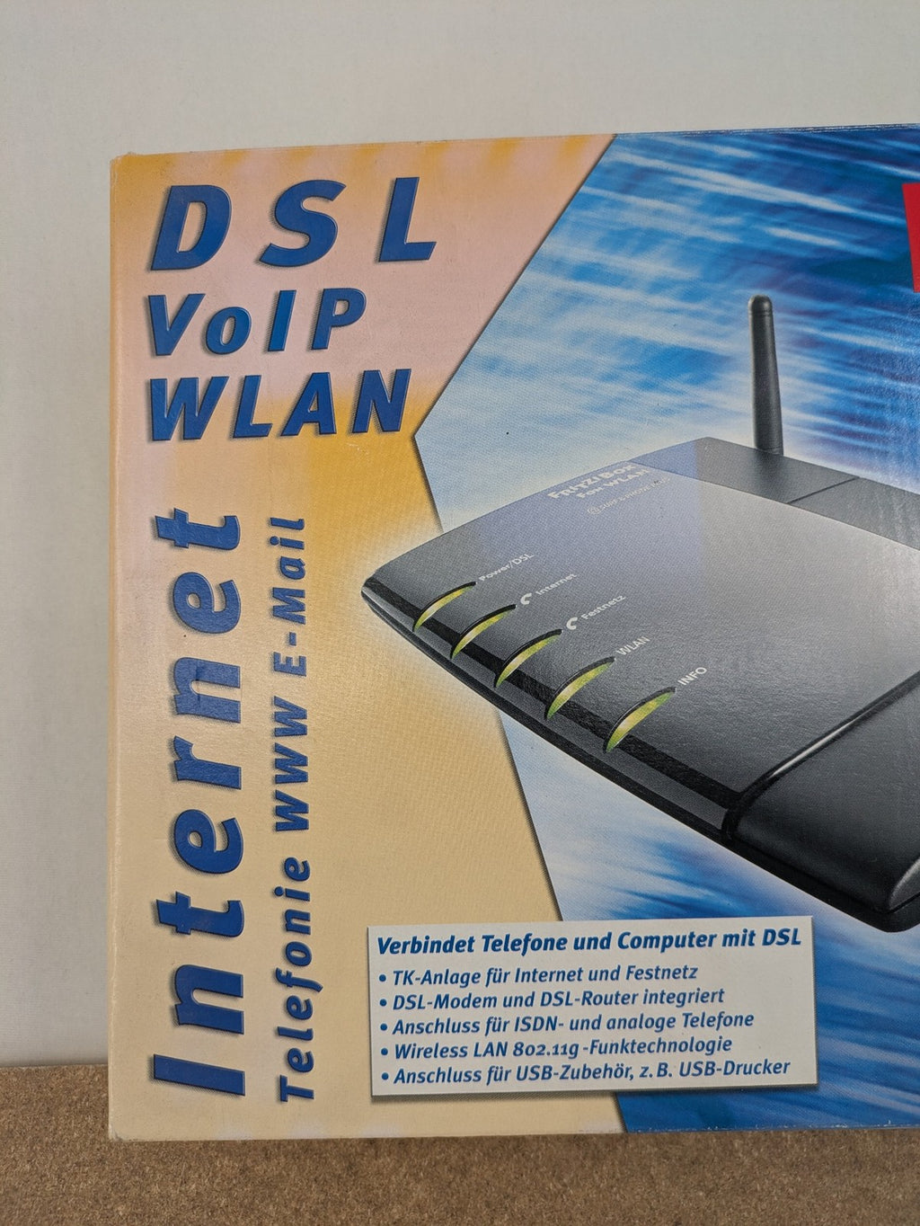 AVM wireless router black grey yellow with logo and integrated DSL modem features.