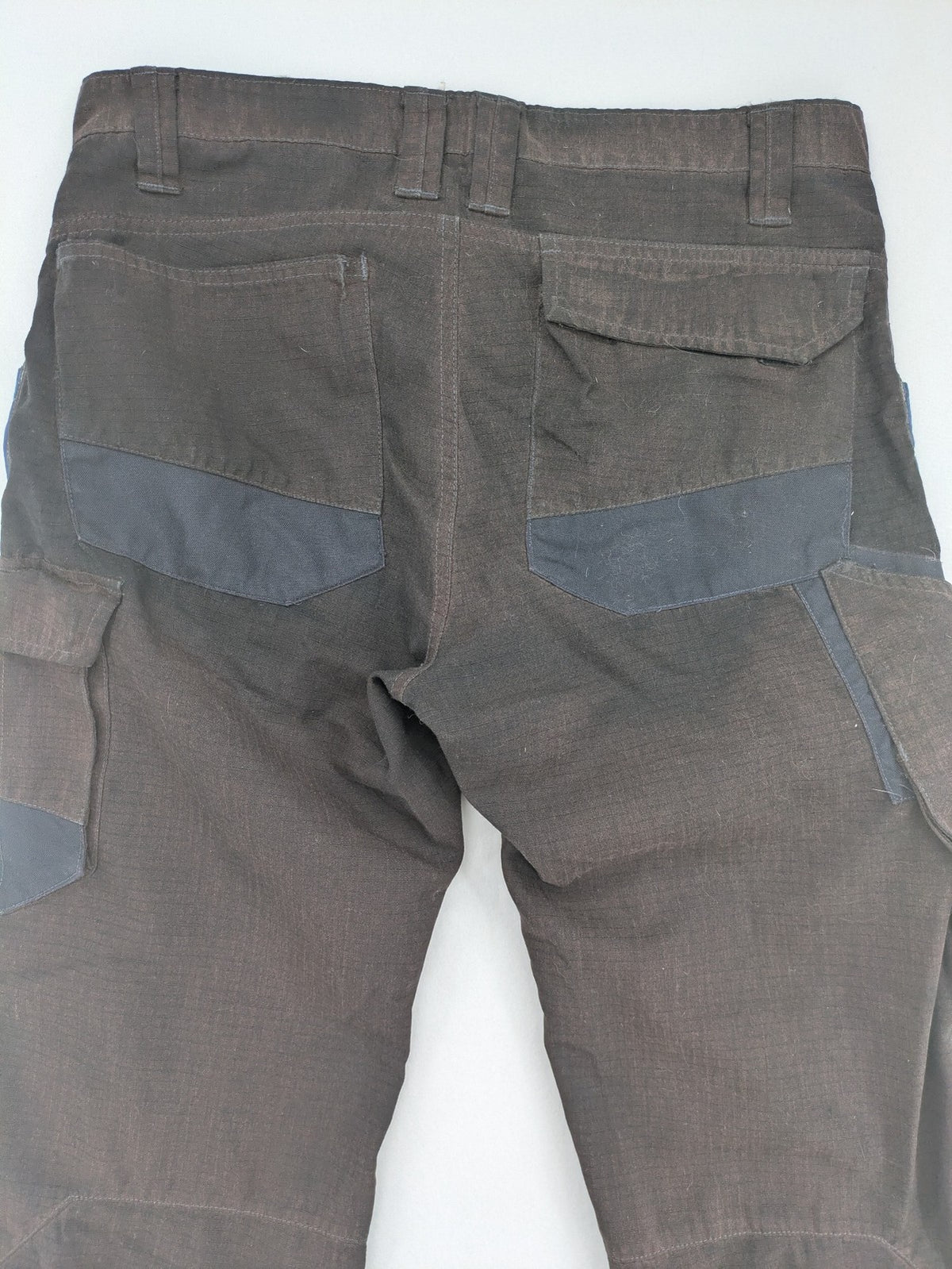 Kübler work pants blue grey Cordura fabric with multiple cargo pockets and reflective details.