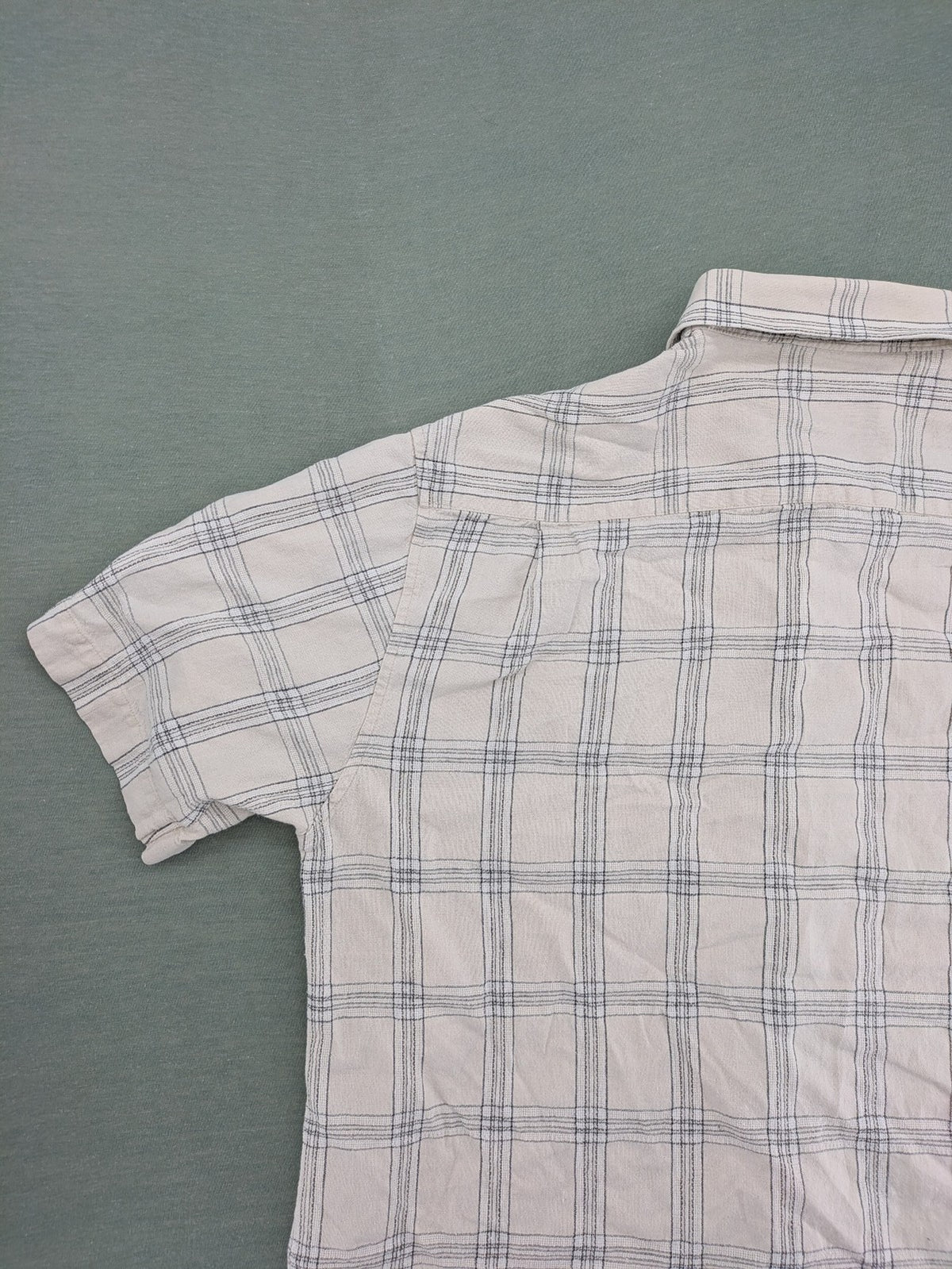 Ken Baker short-sleeve button-down shirt beige blue check pattern with single chest pocket.