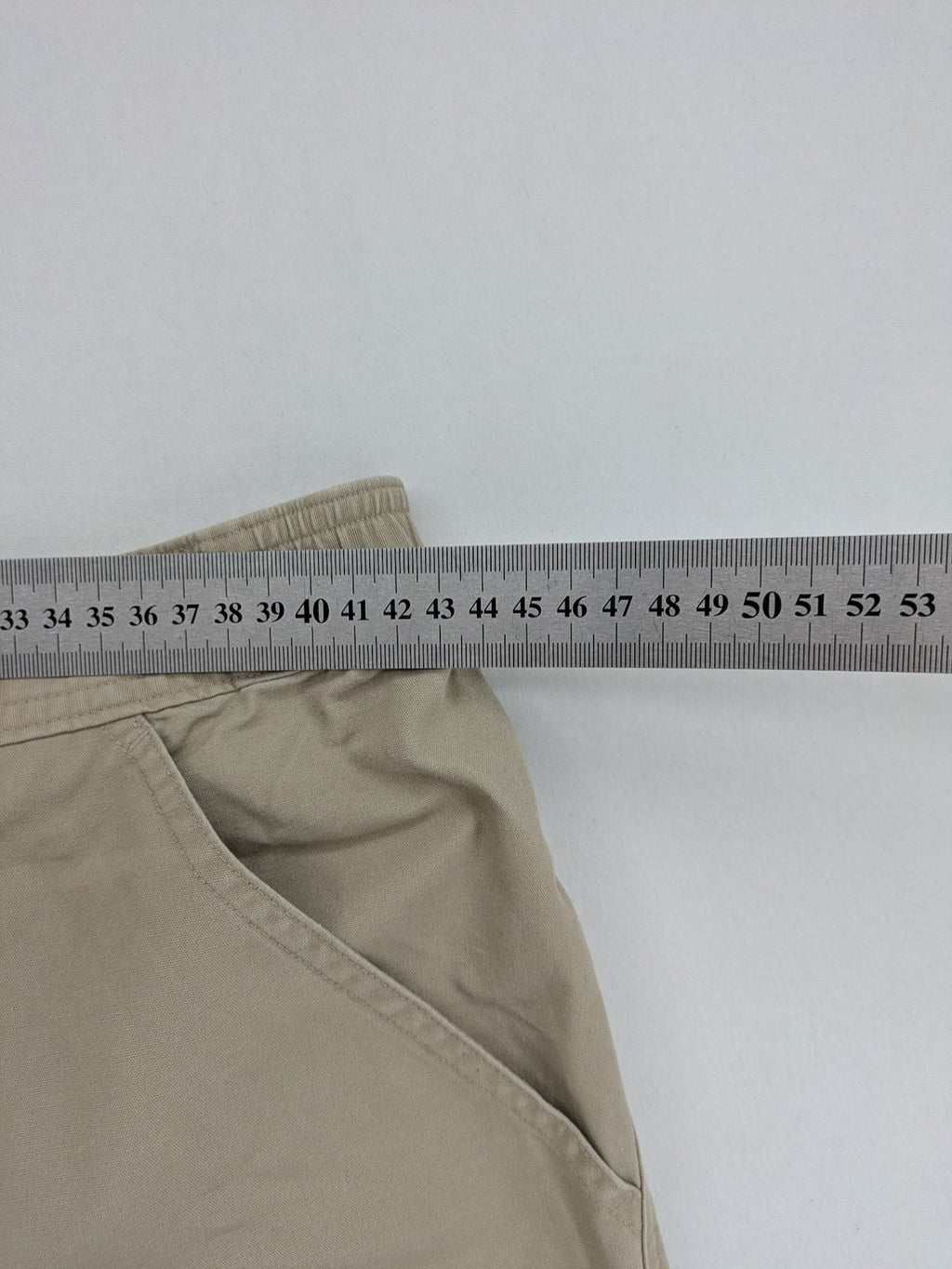 Quechua khaki convertible hiking pants with zip-off legs and durable cotton fabric.