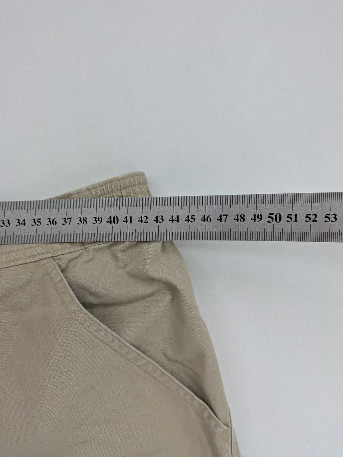 Quechua khaki convertible hiking pants with zip-off legs and durable cotton fabric.