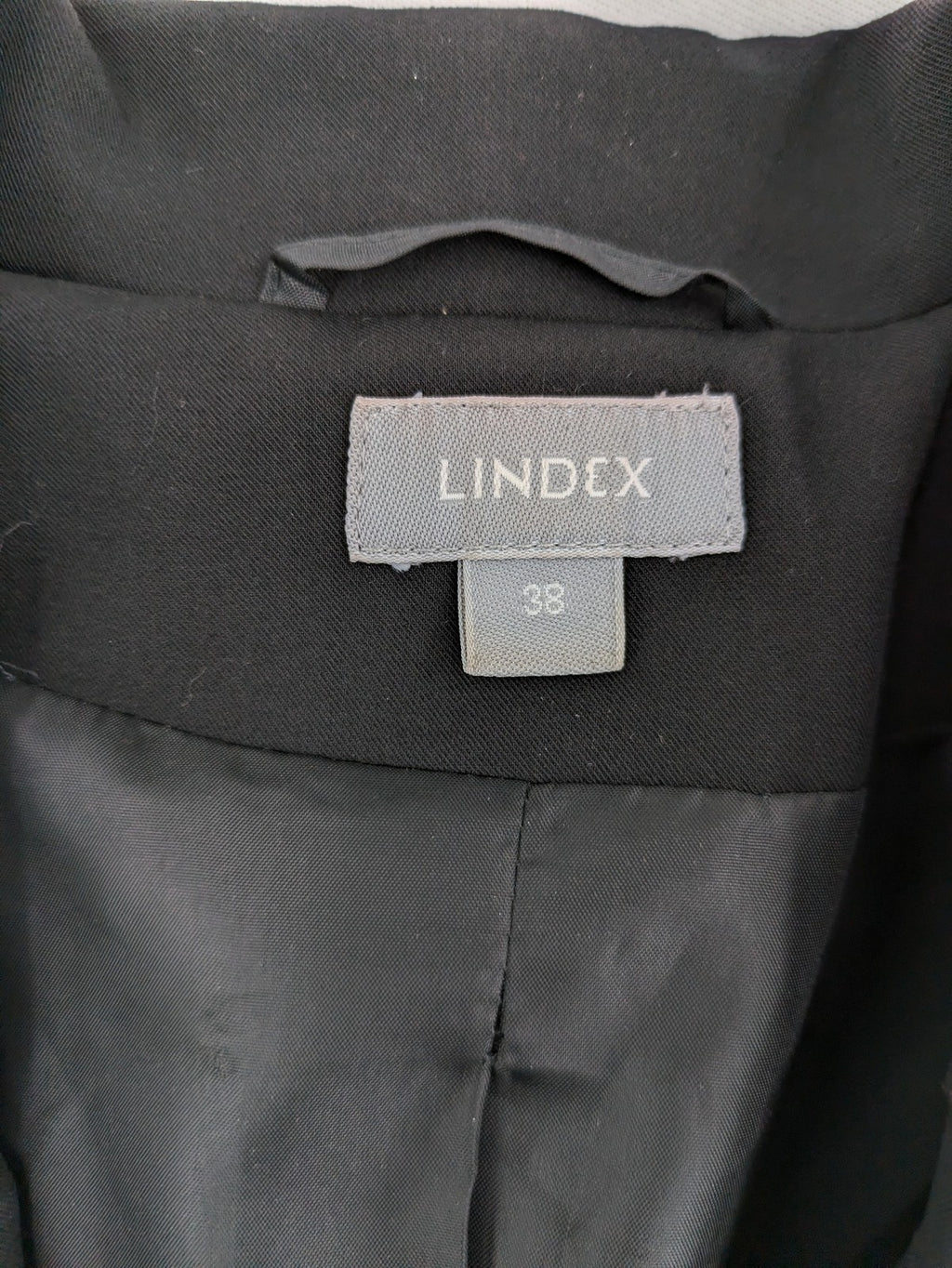 Lindex black blazer coat two-button design with subtle embroidery and tailored silhouette.