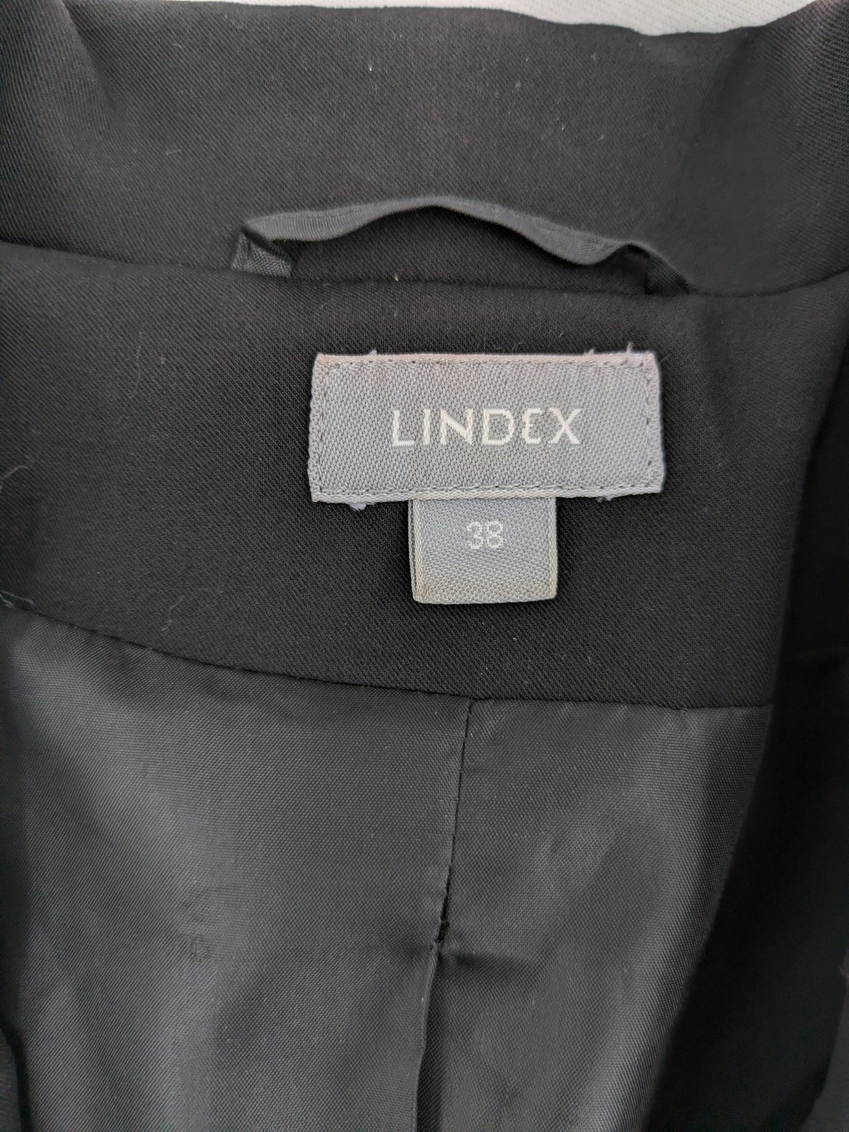 Lindex black blazer coat two-button design with subtle embroidery and tailored silhouette.