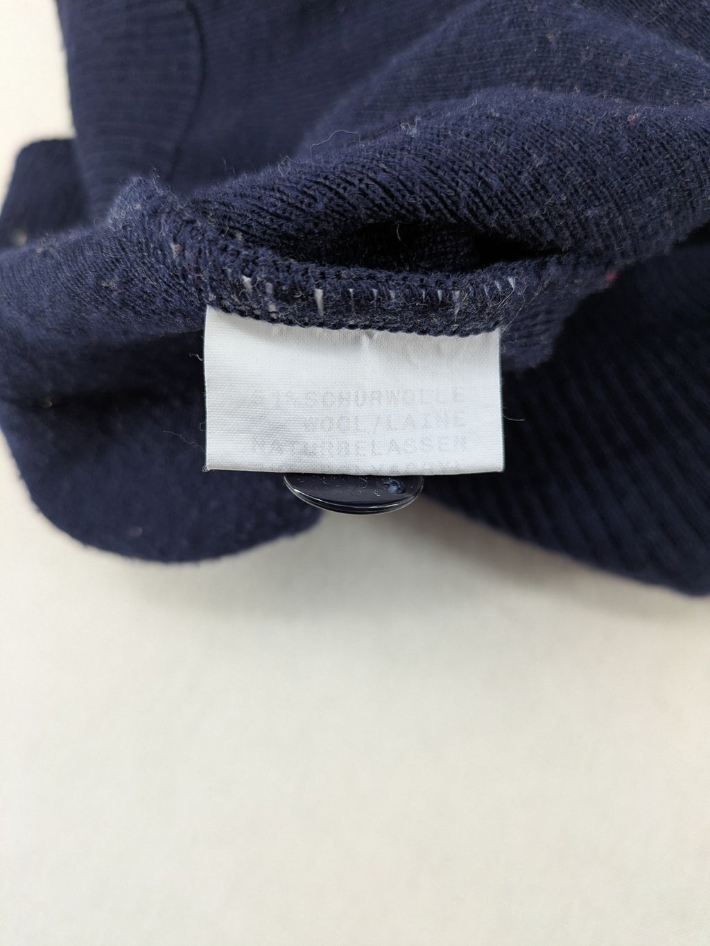 Schurwolle navy knit jumper classic V-neck with button placket, made from wool blend.