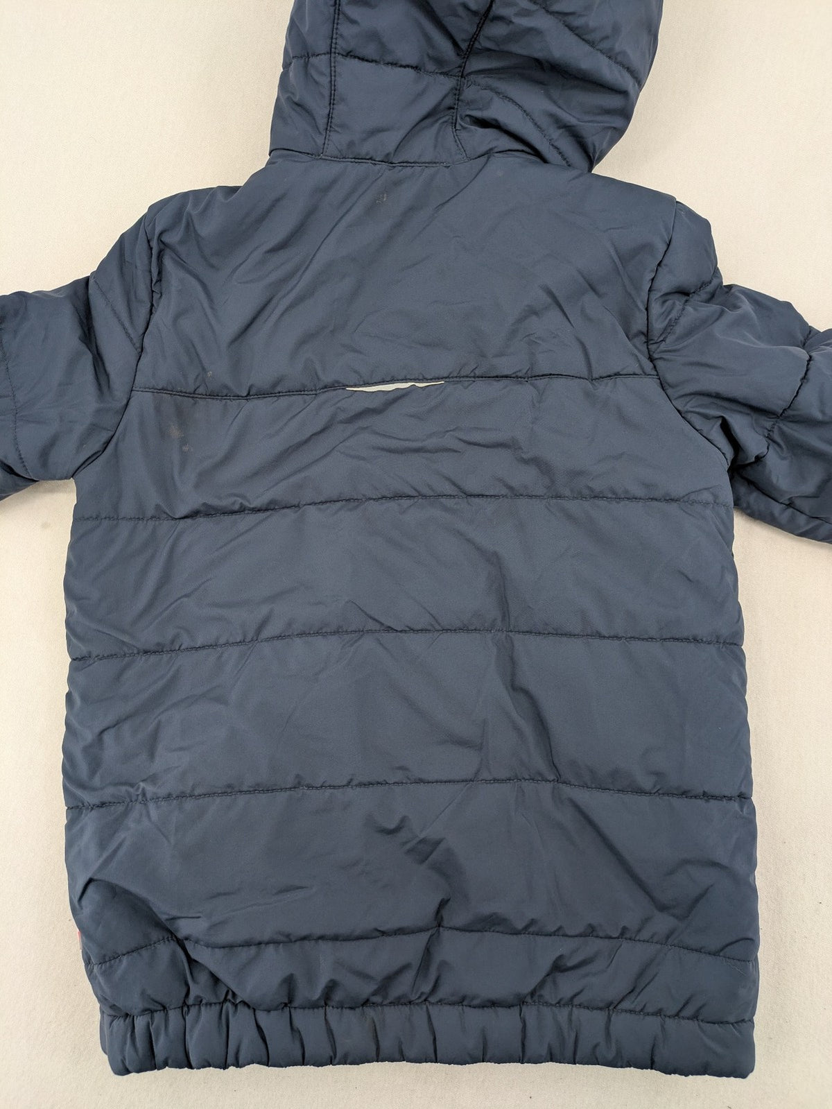 Jack Wolfskin cream and navy puffer coat with quilted design and Sherpa fleece lining.