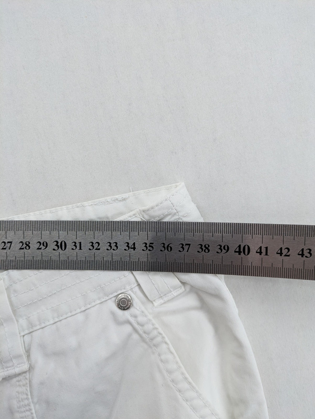 Street One white cargo pants with side pockets and wide leg design.